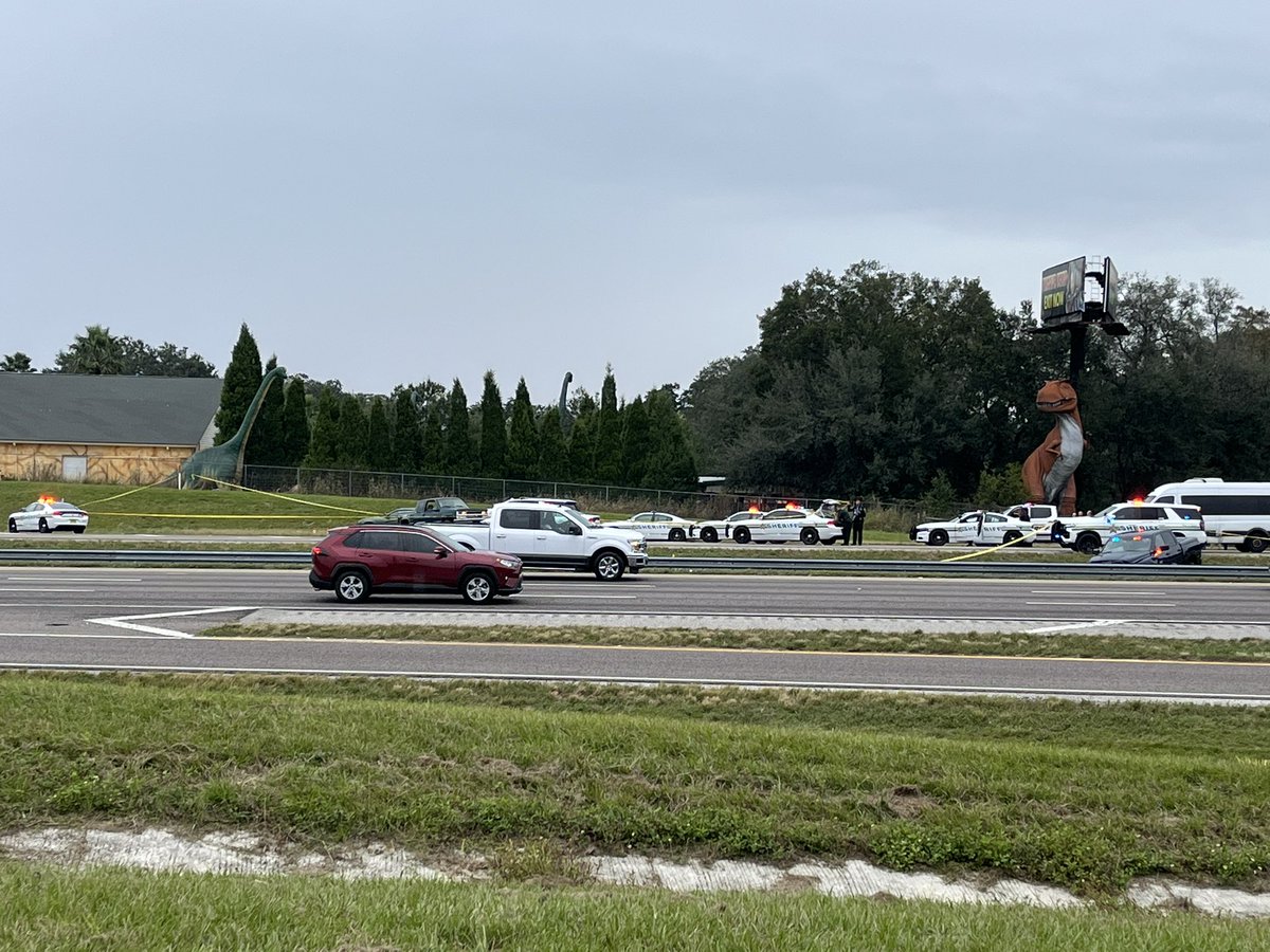 Multiple law enforcement agencies working a scene on I-4 in front of Dinosaur world.