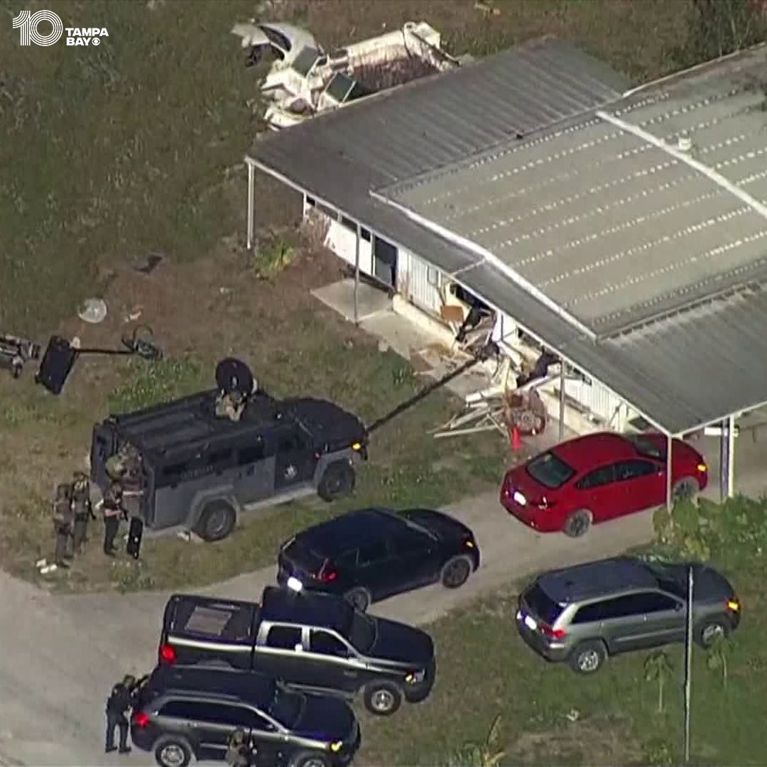 Deputies were shot at while trying to serve a search warrant in Pasco County Friday morning, prompting them to return fire. A person remains inside the home seen here