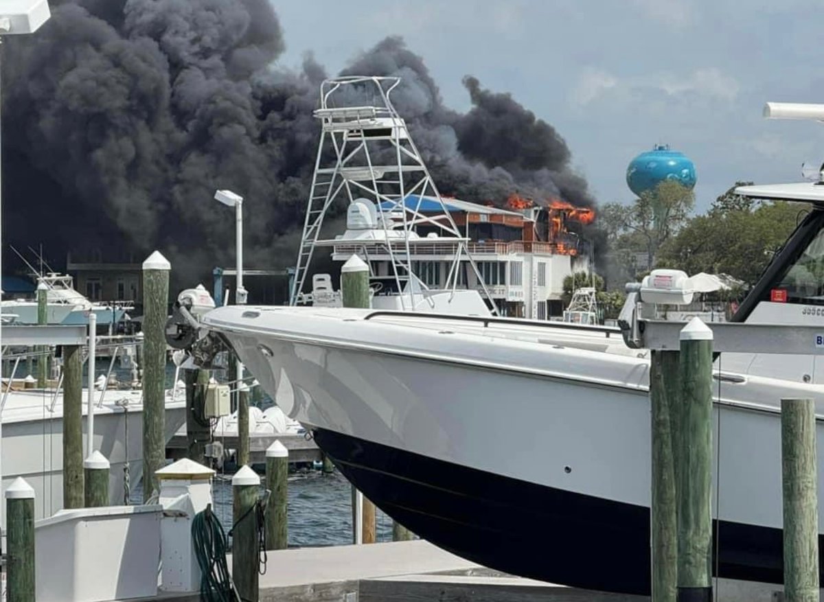 Destin,FL - 2nd Alarm Fire at a Popular Waterfront Restaurant. The road is closed to East bound traffic, because Tailfin's at the Harbor is on fire